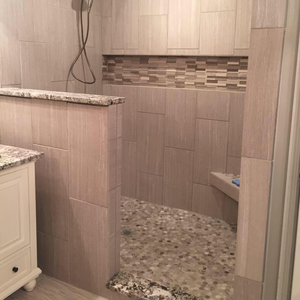 Custom shower with accent band and pebble floor